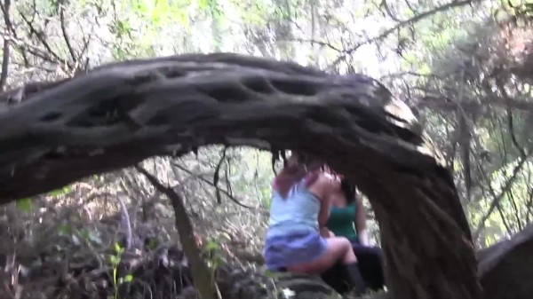 Lesbian lovers licking each other in the woods